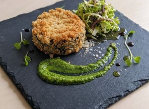 Foto di Medaglione di melanzana gratinata, salsa al basilico e indivia riccia all'acciuga