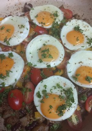 A picture of Mediterranean potato hash with red kidney beans and fried eggs.