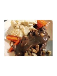 A picture of Beef steak with mashed potato.