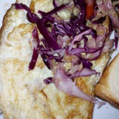 A picture of Omelet eggs garnished with red onions.