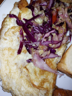 A picture of Omelet eggs garnished with red onions.