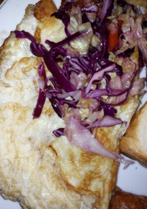 A picture of Omelet eggs garnished with red onions.