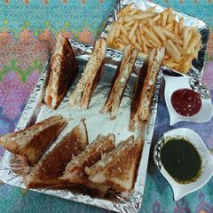 Chicken and eggs cheese sandwiches with french fries A picture of Chicken and eggs cheese sandwiches with french fries.