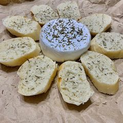 A picture of Baked cheese with baguette.