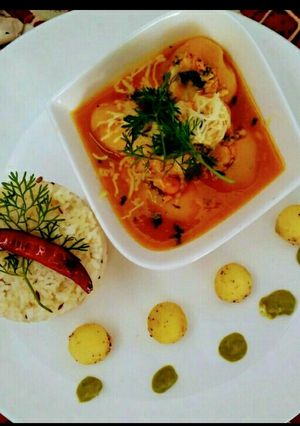 A picture of Paneer stuffing potatoes in Orange juice.