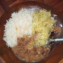 A picture of Stewed beans served with rice and cabbage.
