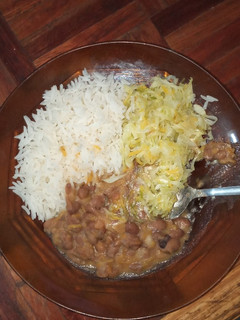 A picture of Stewed beans served with rice and cabbage.