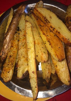 Una foto de Papas rústicas con especias y parmesano!!
