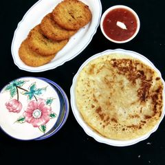 A picture of Chicken cutlas with paratha.