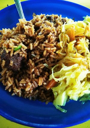A picture of Beef Biryani and Coleslaw.