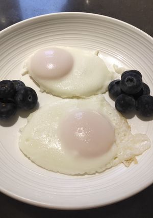 A picture of Poached Eggs with Blueberries.