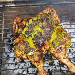 A picture of Spatchcock Chicken with chimichuri.