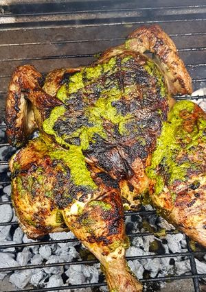 A picture of Spatchcock Chicken with chimichuri.