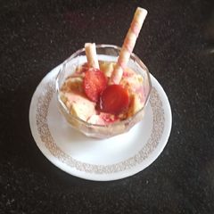 A picture of Custard with strawberry sauce.
