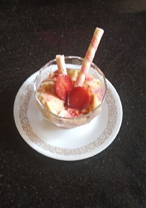 A picture of Custard with strawberry sauce.