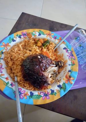 A picture of Jollof rice with grilled turkey.