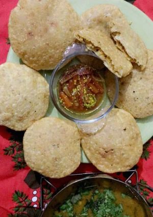 A picture of Daal kachori with aloo bhaji +gajar moli ka pani wala achar.