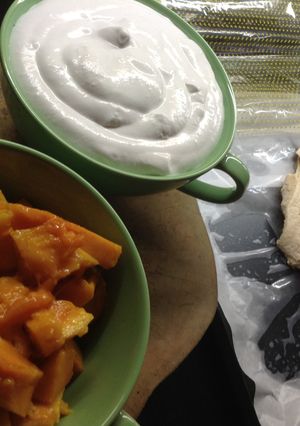 A picture of Pavlova with whipped cream and fresh mango.