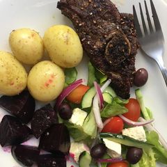 A picture of Roasted dukkah spiced lamb chops with baby potatoes and salad.