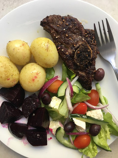 A picture of Roasted dukkah spiced lamb chops with baby potatoes and salad.