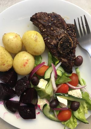 A picture of Roasted dukkah spiced lamb chops with baby potatoes and salad.