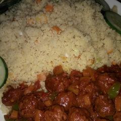 A picture of Stir fry couscous with meat balls stew.