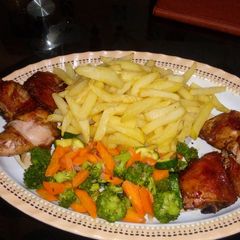 A picture of Roast chicken with Fries and mixed vegetables.