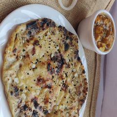 Stuffed aloo kulcha with masala paneer A picture of Stuffed aloo kulcha with masala paneer.