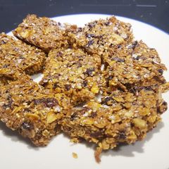 A picture of Apricot and almond flapjacks with honey and seeds.
