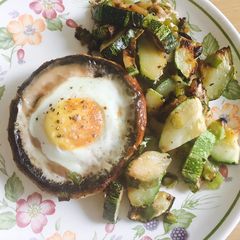 A picture of Egg on mushroom with courgette.