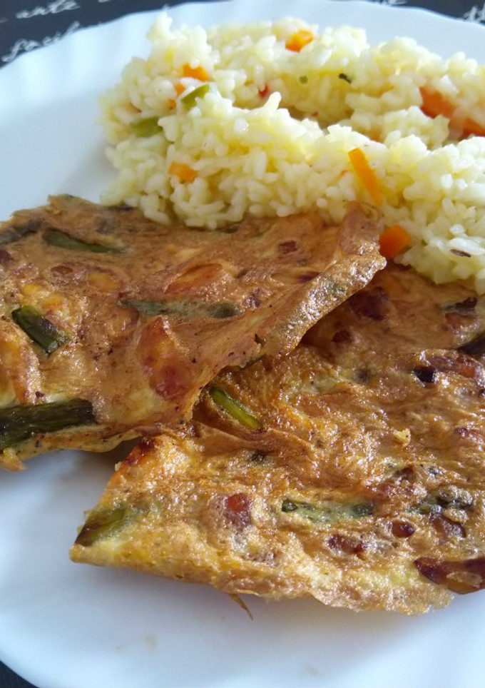 Una foto de Tortilla de pollo, ajos verdes y espárragos.Acompañada de arroz