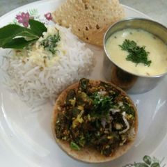 A picture of Bhindi, Kadhi, rice with satha roti, papad.