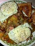 Sausage, ham and fried potato skillet topped with eggs