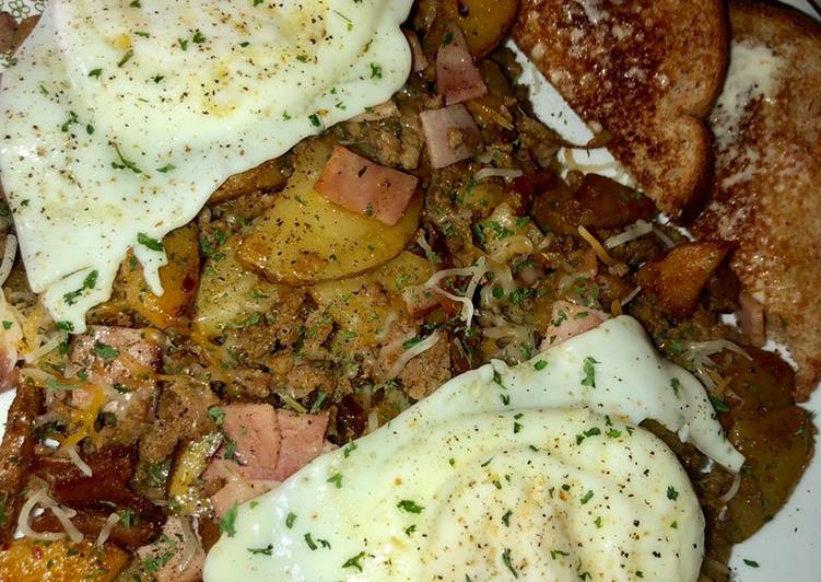 Sausage, ham and fried potato skillet topped with eggs