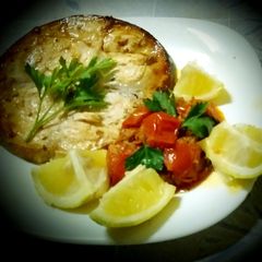 A picture of Grilled swordfish and cherry tomato sauce, swordfish, capers.
