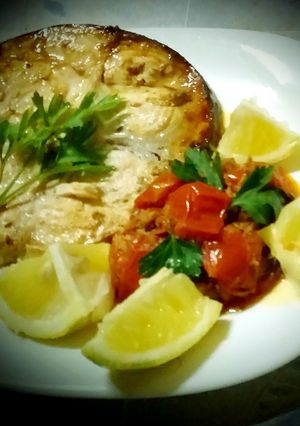 A picture of Grilled swordfish and cherry tomato sauce, swordfish, capers.
