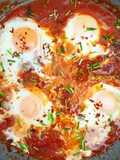 Baked egg with red sauce