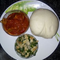 A picture of Pounded yam and stew with spinach egg sauce.