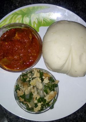 A picture of Pounded yam and stew with spinach egg sauce.