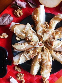 Una foto de Endivias al horno con pera, rulo de cabra y nueces