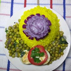 A picture of Tumeric rice with egg curry.