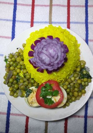 A picture of Tumeric rice with egg curry.