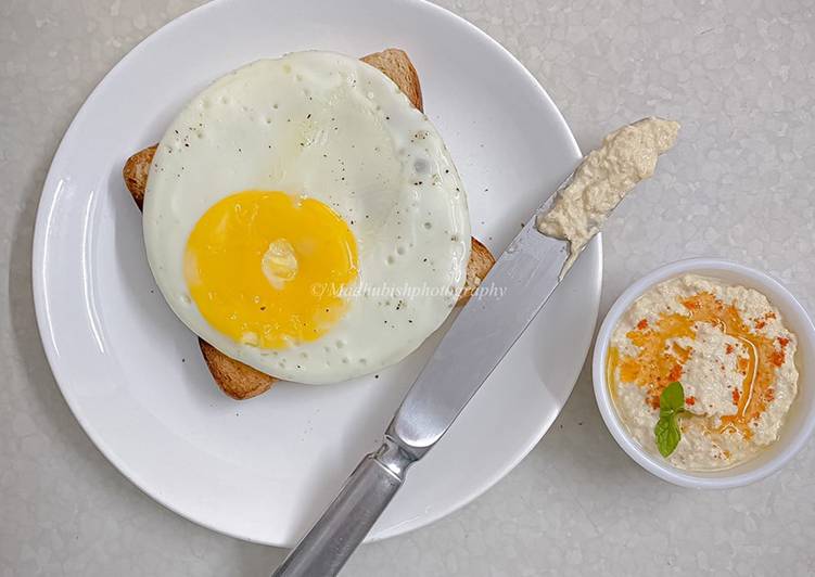 Olive oil fried egg and hummus toast