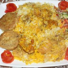 A picture of Sindhi baryani + kuchumar salad + shami kabab.