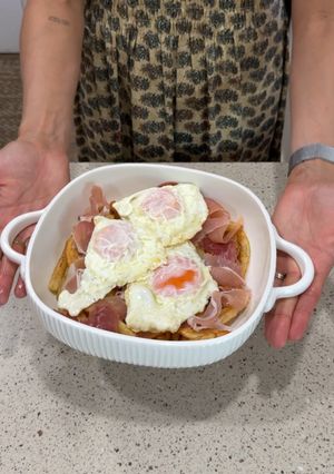 A picture of SPANISH TAPA 4 INGREDIENTS - Huevos Rotos con Jamón | Potatoes with Eggs and Spanish Ham.
