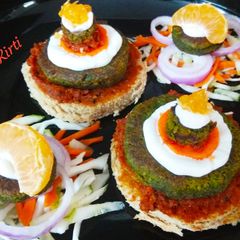 A picture of Hot & Tangy Cheakpea Spinach Tikki Open sandwich.