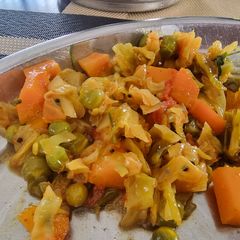 A picture of Cabbage carot peas sabzi in pressure cooker.