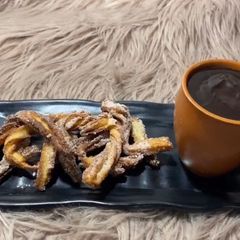 A picture of Churros with hot chocolate.