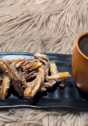 A picture of Churros with hot chocolate.