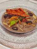 Crema de frijol y costra de quesillo con chapulines